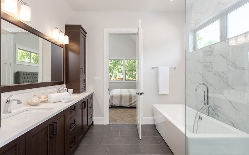 Modern bathroom with a large walk-in shower and a double sink, designed for functionality and elegance.