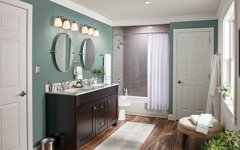 A clean bathroom featuring a white tub and a modern sink against a neutral wall.