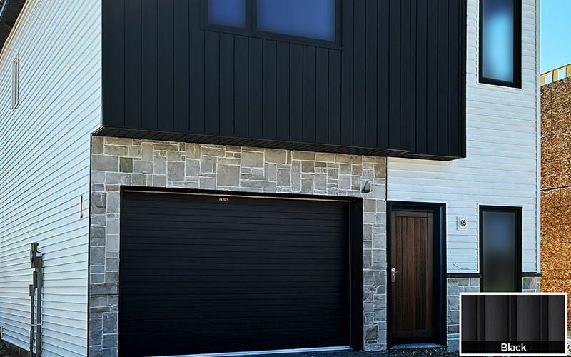 A contemporary home featuring sleek black garage doors, showcasing modern architectural design.