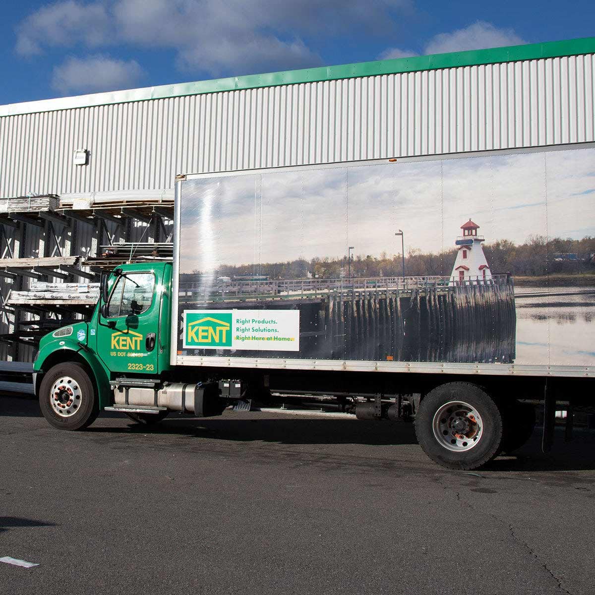 KENT delivery truck parked outside with branded logo and a scenic lighthouse graphic on the side image